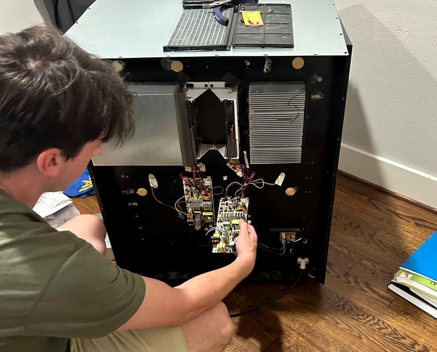 Built-in coffee machine opened from rear panel during power board diagnostics and electronic repair