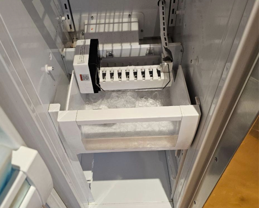 Built-in refrigerator freezer section during ice maker replacement and ice production repair
