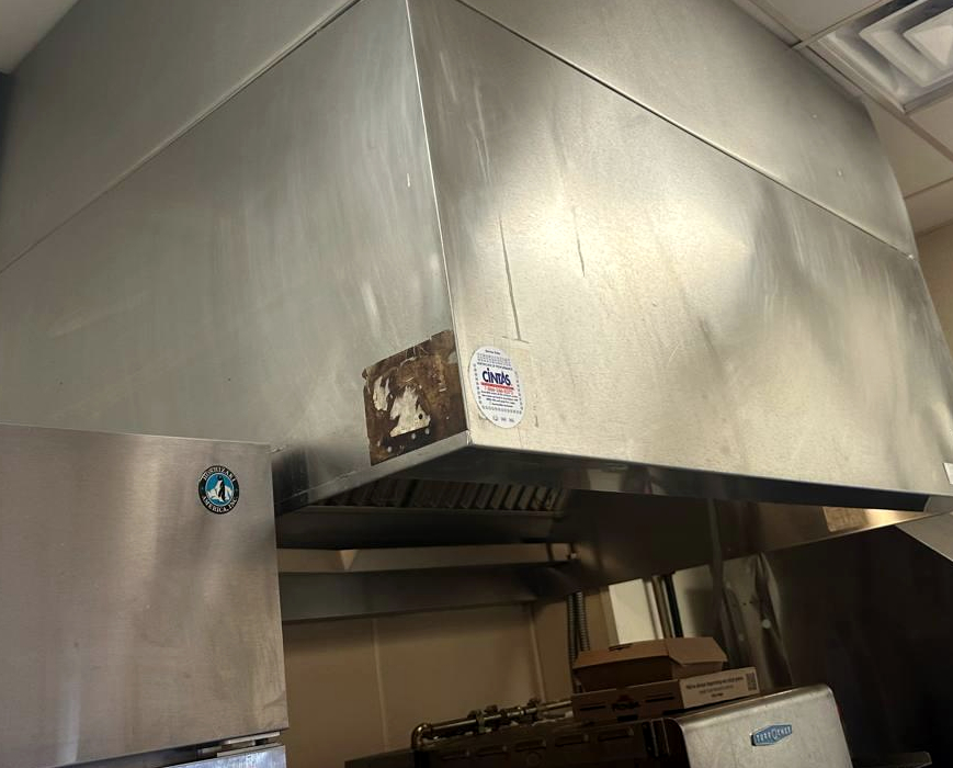 Commercial kitchen exhaust hood during ventilation fan repair and airflow service