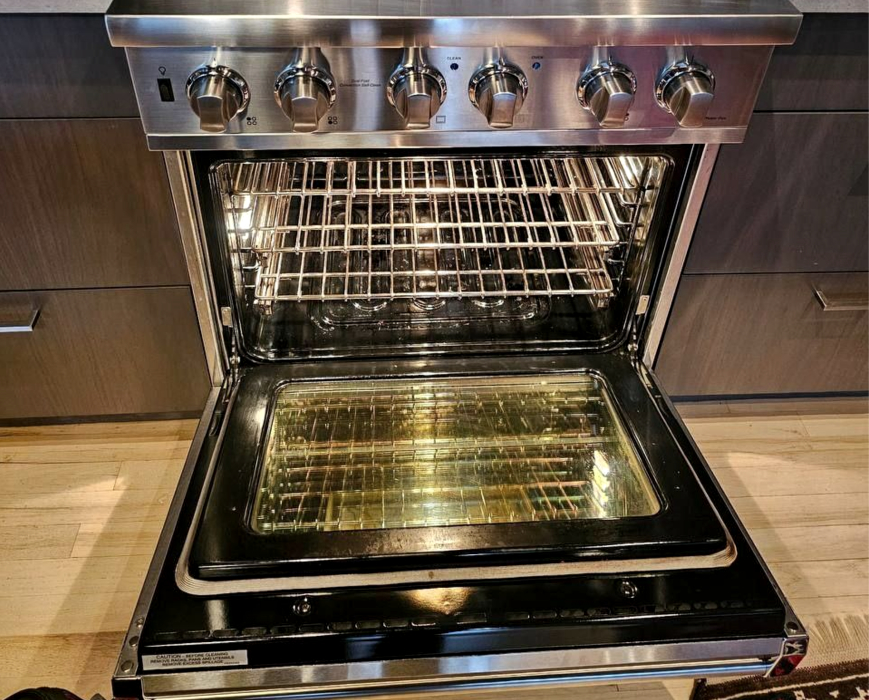 Thermador gas range with oven door open during convection fan repair and performance testing