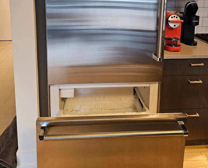 Viking built-in refrigerator with lower freezer drawer opened during ice buildup and defrost system repair